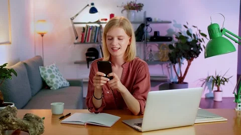 Portrait of joyful millennial using social media application on black mobile Stock Footage 115910832