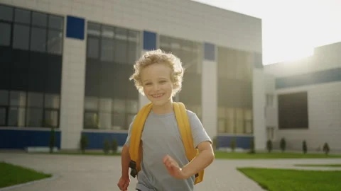 Portrait Of Joyful Smiling Boy With Backpack Running From School Building, Slow Stock Footage 249020826