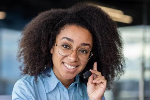 Portrait of joyful successful support worker, woman with headset phone close up Stock Photos