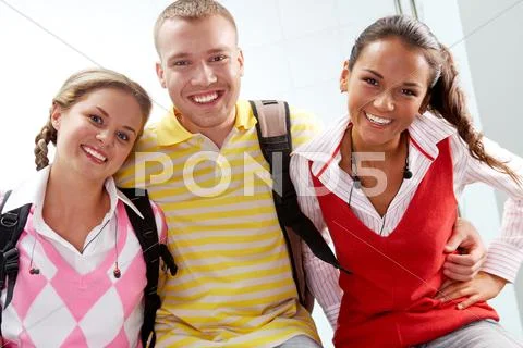 Portrait of joyful teens embracing and looking at camera with laugh Stock Photos