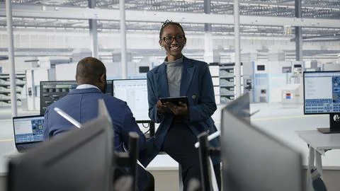 Portrait of joyous female engineer in microchip factory RD office Stock Photos