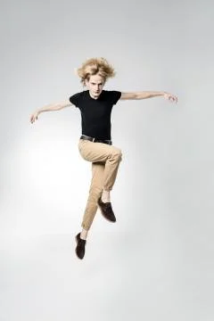 Portrait of a jumping man on a light background. Stock Photos
