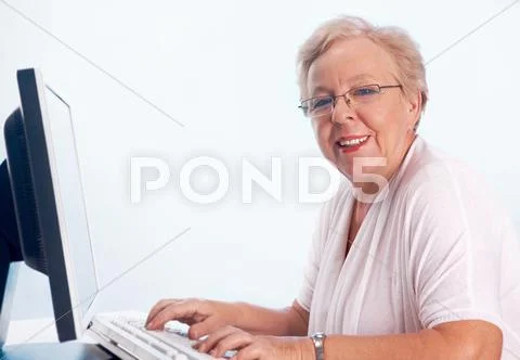 Portrait of kind and friendly woman typing and looking at camera Stock Photos