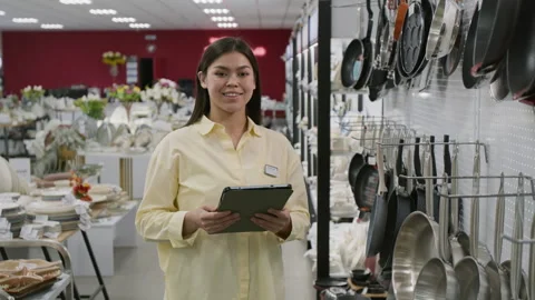 Portrait of Kitchenware Store Manager with Tablet next to Cookware Display Stock Footage 321769387