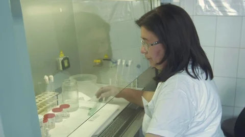 Portrait of lab technician while analyzes tuberculosis bacillus by Pakito. Stock Footage 74821345