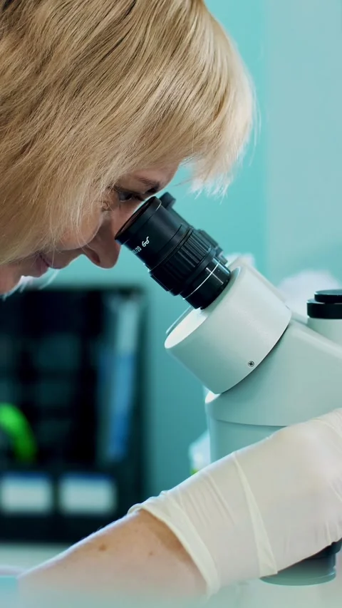 Portrait of lab worker, biochemist in white gloves, studying, examines something Stock Footage 313866237