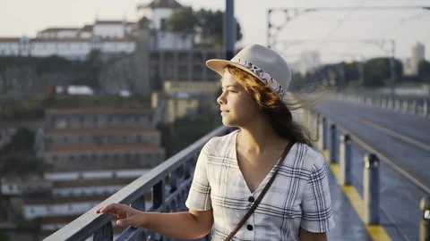 Portrait Lady in hat walking on bridge at sunrise Stock-Footage 99387524