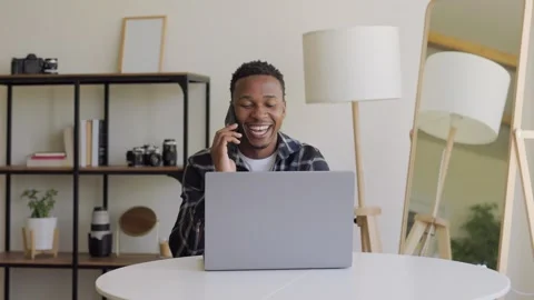 Portrait of a laughing black guy talking on the phone. A relaxed, serious guy of Stock Footage 264116437
