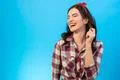 The portrait of the laughing woman on the blue background Photo