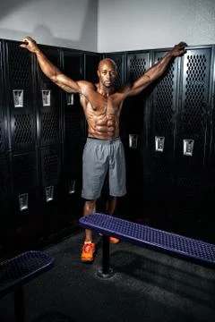 Portrait of a lean toned and ripped muscle fitness man under dramatic low key Stock Photos