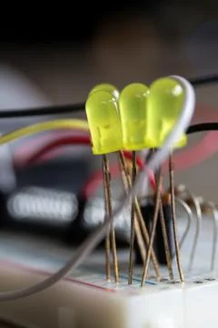 A portrait of LEDS wired into a breadboard creating an electronic circuit wit Foto stock
