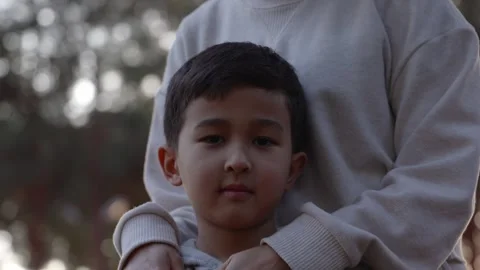 Portrait of little boy looking at camera when mother holds him Stock Footage 244828732