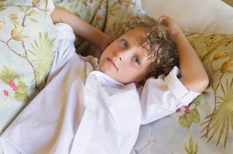 Portrait of a little boy lying on couch Stock Photos