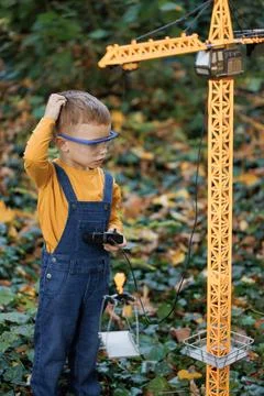 Portrait of little boy with remote control from radio-controlled toy mobile Stock Photos