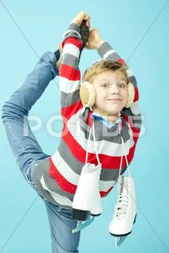 Portrait of a little boy with skates stretching his leg Stock Photos