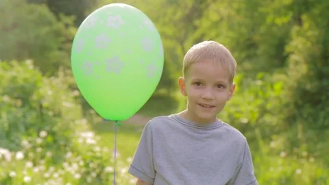 Portrait of a little boy smiling to the camera with a balloon Stock Footage 85001519