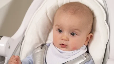 A portrait of a little boy smiling while lying in baby seat. True emotions. Stock Footage 108741362