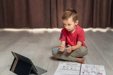 Portrait of little boy using digital tablet at home Stock Photos