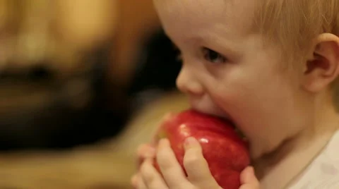 Portrait of a Little boy who eats the big Apple. Closeup. Stock Footage 68367895