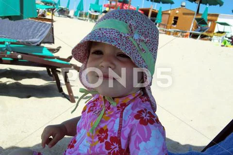 Portrait of little cute blond girl on the beach Stock Photos