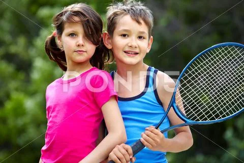 Portrait of a little girl and boy with badminton racket Stock Photos