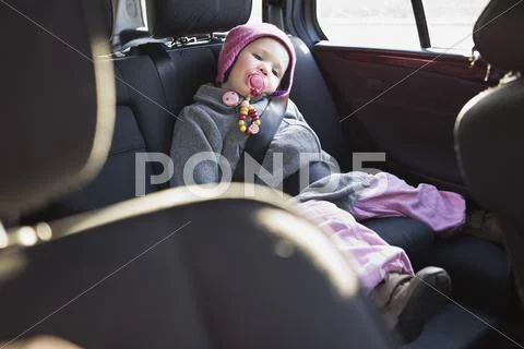 Portrait Of Little Girl In Back Seat Of Car