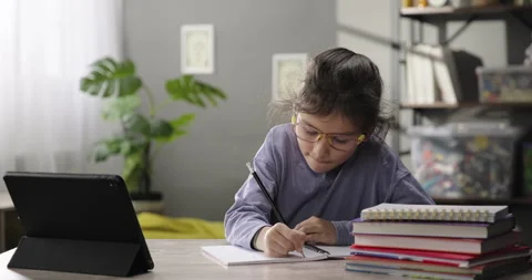 Portrait of a little girl e-learning online using app or website on digital Stock Footage 269052207