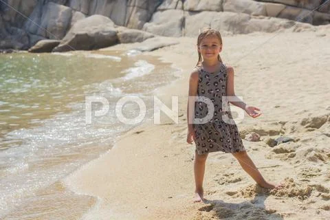 Portrait of Little girl on the sandy beach. Summer vacation. Stock Photos