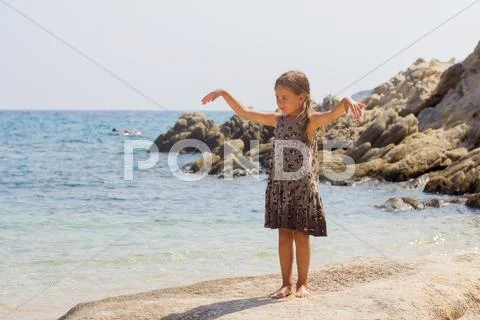 Portrait of Little girl on the sandy beach. Summer vacation. Stock Photos