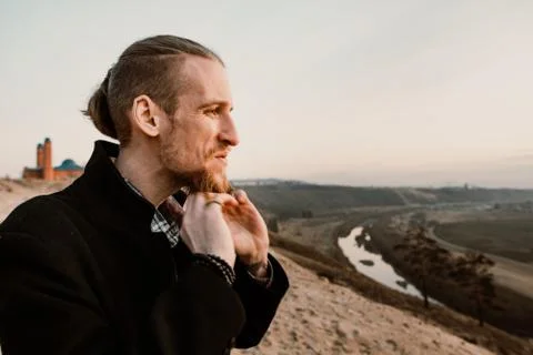 Portrait of long haired bearded guy in the susnet Stock Photos