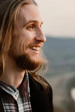 Portrait of long haired bearded guy in the susnet Stock Photos