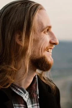 Portrait of long haired bearded guy in the susnet Stock Photos