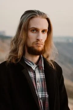 Portrait of long haired bearded guy in the susnet Stock Photos