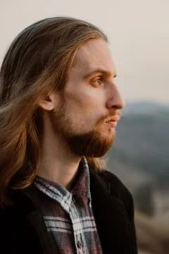 Portrait of long haired bearded guy in the susnet Stock Photos