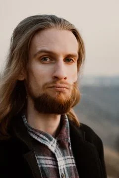 Portrait of long haired bearded guy in the susnet Stock Photos