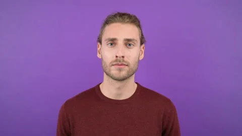 Portrait of long-haired man seriously looking at the camera 4K Stock Footage 145473029