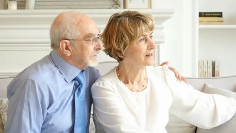 Portrait of lovely elderly pair spending time together at home Stockbeeldmateriaal 99695120