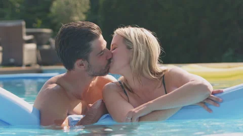 Portrait Of Loving Couple Having Fun On Summer Vacation Floating On Airbed In Stock Footage 150657993