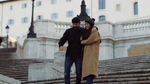 Portrait of a loving couple walking down the Spanish Steps together. 4k RED came Stock Footage 199456265