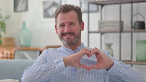 Portrait of Loving Middle Aged Man with Heart Gesture Stock Footage 287898662