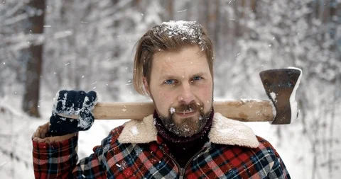 Portrait of lumberjack standing in snowy forest with axe 스톡 동영상 125161153
