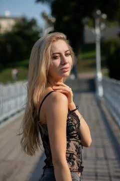 Portrait of luxury model with natural makeup wearing lace top, posing with su Stock Photos