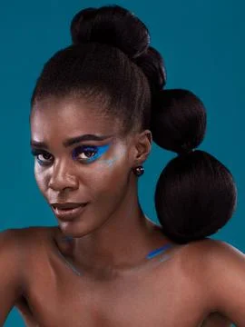 Portrait, makeup and bold with a model black woman in studio on a blue Stock Photos