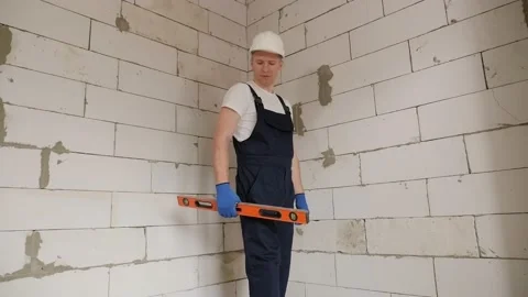 Portrait of a male construction worker with a construction level in his hands. Stock Footage 168248031