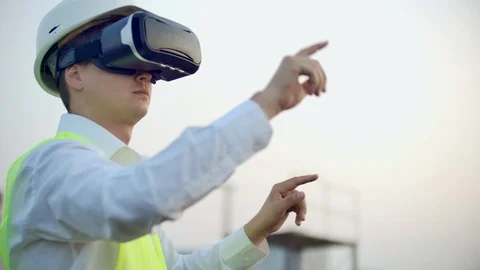 Portrait of a male crane operator operating a construction site using virtual Video stock 114423129