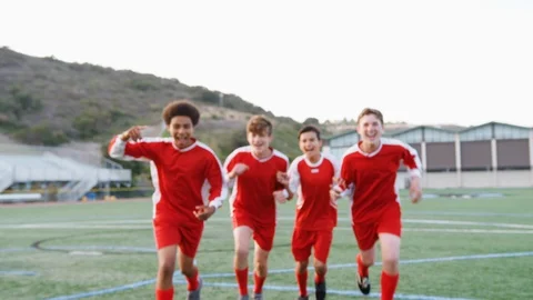 Portrait Of Male High School Soccer Team Running Towards Camera And Celebrating Stock Footage