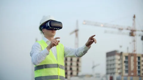 Portrait of a male inspector analyzing the work of builders using virtual Video stock 114423026