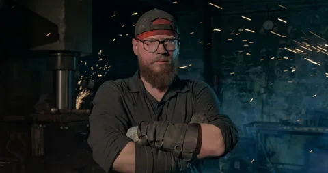 Portrait of a male master in a workshop in the pillars of sparks Stock Footage 145128402