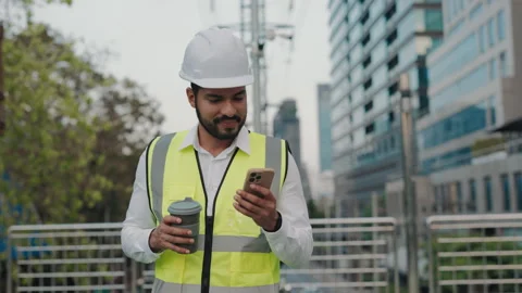 Portrait of male taskmaster with coffee cup reading in phone on bridge Stock Footage 305761957