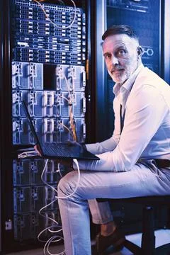 Portrait, man and programming with laptop in server room for research, coding Stock-Fotos